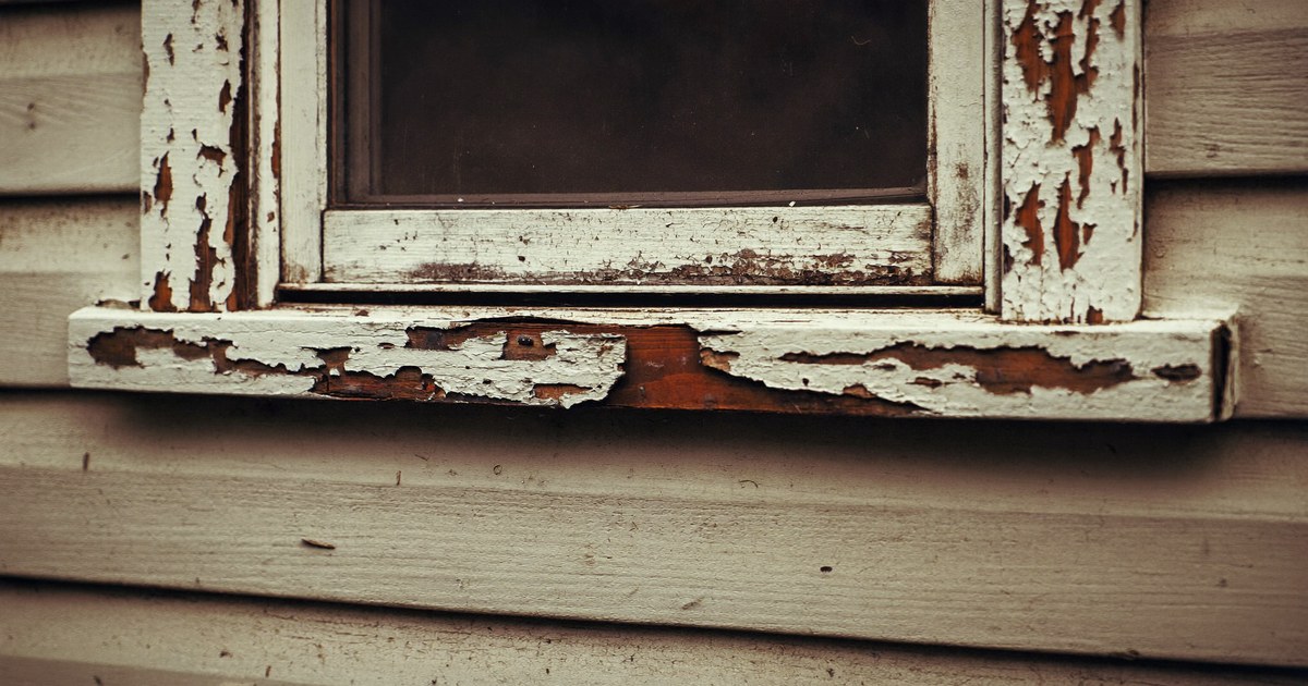 A pre-1978 New Jersey home exterior with aged painted trim